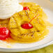 A plate of Dole pineapple rings topped with ice cream and a cherry.