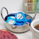 A bowl of International Delight French Vanilla non-dairy creamer in a bowl of yogurt next to a cup of coffee.