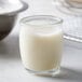 A close-up of a glass container with white liquid.