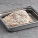 A metal pan of Original Philly Cheesesteak Co. fully cooked sliced beef steak.