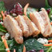 A salad with Brakebush fajita chicken strips, spinach, and carrots.