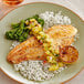 A plate of Golden Phoenix Swai fillet with rice and broccoli.