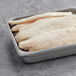 A tray of frozen Golden Phoenix Swai fillet portions.