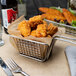 A basket of Brakebush Doo-Wa Ditties breaded chicken breast wing fritters.
