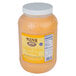 A plastic container of Ken's Foods Golden Italian dressing on a counter.