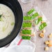 A bowl of soup with a bag of Burry Foods Homestyle Seasoned Croutons.