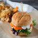 A chicken burger on a Rotella's Italian Bakery hamburger bun with a toothpick.