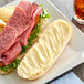A sandwich on a plate with Duke's Heavy Duty Mayonnaise on it.
