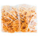 A white plastic bag of McCain Foods Redstone Canyon Skin-On Spiral Fries.