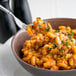 A fork in a bowl of pasta with Casa Di Lisio Sundried Tomato Pesto.