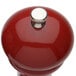 A Chef Specialties red pepper mill with a silver top.