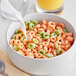 A close-up of a bowl of Kellogg's Apple Jacks cereal with milk being poured into it.