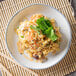 A plate of Par Excellence parboiled white rice with shrimp and vegetables on a bamboo mat.