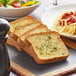 A plate of spaghetti with Burry Thick Texas Toast on it.