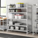 A Cambro Premium Camshelving unit with vented shelves holding containers on a kitchen shelf.