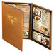 A brown Menu Solutions Bella Collection menu cover on a table with food.