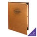 A brown leather Menu Solutions Bella Collection menu cover on a table.