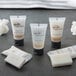 A white bottle of Novo Essentials Hotel and Motel Body Lotion with a brown label.