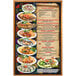 A Menu Solutions Bella Collection leather-like menu cover on a table with a plate of food.