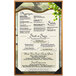 A Bella Collection soft leather-like menu cover on a table in a farm-to-table restaurant.