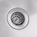 A close-up of a stainless steel sink drain for a Regency wall mounted hand sink.