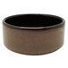 A brown porcelain ramekin with a black rim.