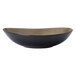 A white porcelain soup bowl with a black bowl and brown rim.