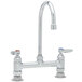 A chrome T&S deck-mounted pantry faucet with swivel gooseneck nozzle and wrist action handles.