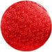 A red round Enjay cake drum with leaves on it.