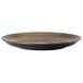 A brown Oneida Rustic chestnut porcelain coupe plate with a black rim.