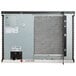 A Manitowoc air cooled ice machine with a door and fan.