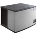 A rectangular black and grey Manitowoc air cooled ice machine.