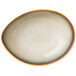 A close-up of a white Oneida Rustic Sama porcelain soup bowl with an orange rim.