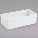 A white rectangular container on a gray surface.