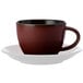 An Oneida Rustic crimson porcelain coffee cup on a white saucer.