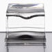 A clear glass cube with a black circle inside of it.