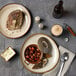 Oneida Rustic porcelain pizza plate with food on it and a bottle of beer.