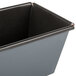 A close up of a black metal Matfer Bourgeat flared bread loaf pan.