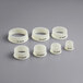 A set of white plastic rings with black text.