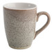 A white porcelain mug with a speckled brown design.