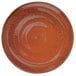 A brown Oneida Terra Verde Cotta porcelain coupe plate with black specks.