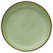 A celadon green porcelain tapas dish with a brown rim.