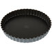 A black Matfer Bourgeat fluted non-stick tart pan with a removable bottom.
