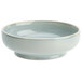A white porcelain ramekin with a light blue rim.
