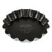 A black fluted tartlet mold.