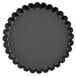 A black round Matfer Bourgeat fluted tart pan with a scalloped edge.