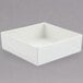 A white square Bon Chef bowl with a sandstone finish on a grey surface.