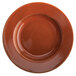 A brown Terra Verde Cotta porcelain pasta dish with a rim.