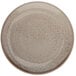A close-up of a Oneida Terra Verde Natural porcelain coupe plate with brown and white speckles.