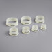 A group of white plastic Matfer Bourgeat round dough cutters with black text.